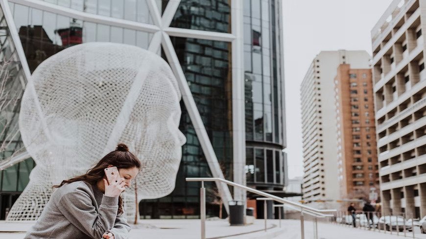 Girl talking on phone in public square